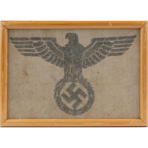 750 - A German military interest section of a military grain sack with eagle and Swastika, framed, overall... 