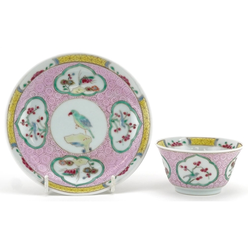 99 - A 20th century Chinese porcelain tea bowl and saucer on stand hand painted with a bird and cherry bl... 