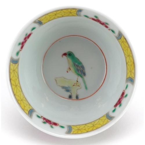 99 - A 20th century Chinese porcelain tea bowl and saucer on stand hand painted with a bird and cherry bl... 