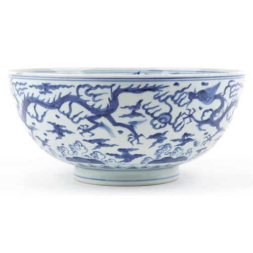  A large Chinese blue and white porcelain footed bowl hand painted with dragons chasing flaming pearl... 