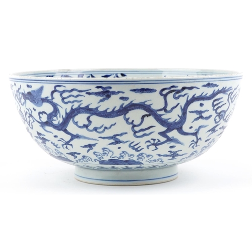  A large Chinese blue and white porcelain footed bowl hand painted with dragons chasing flaming pearl... 