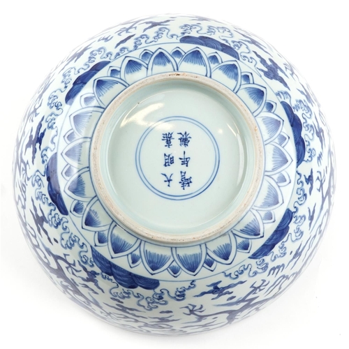  A large Chinese blue and white porcelain footed bowl hand painted with dragons chasing flaming pearl... 