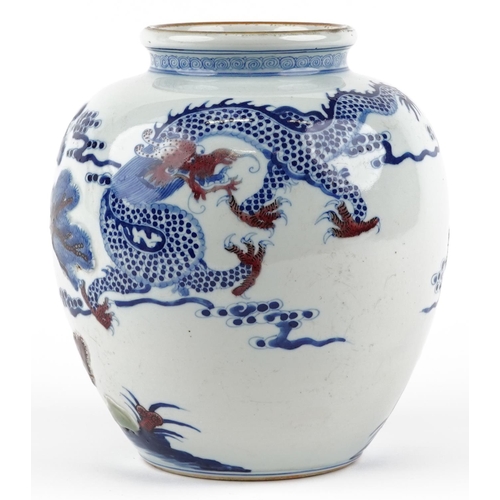 48 - A Chinese blue and white with iron red porcelain vase relief decorated and hand painted with a drago... 