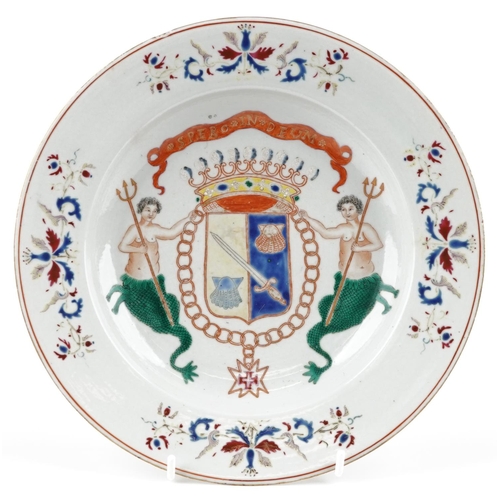 98 - A Chinese porcelain shallow dish hand painted with an armorial crest and mermaids, 22.5cm high.