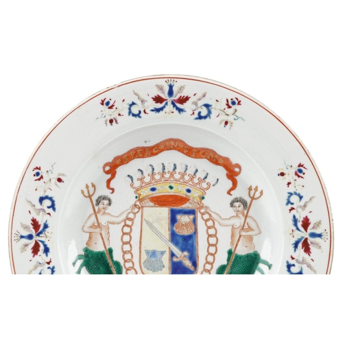 98 - A Chinese porcelain shallow dish hand painted with an armorial crest and mermaids, 22.5cm high.