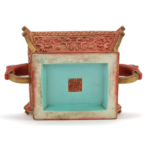 96 - A Chinese porcelain partially gilt box and cover in the form of a casket with mythical animal head h... 