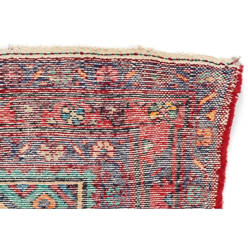 1017 - A Turkish rug, late 20th century, the red field with a central stylized medallion within a complemen... 