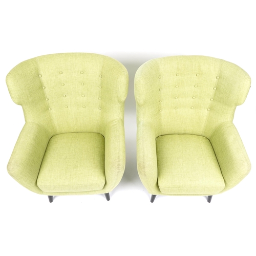 1013 - A pair of modern button back armchairs upholstered in green fabric raised on ebonised tapering legs,... 