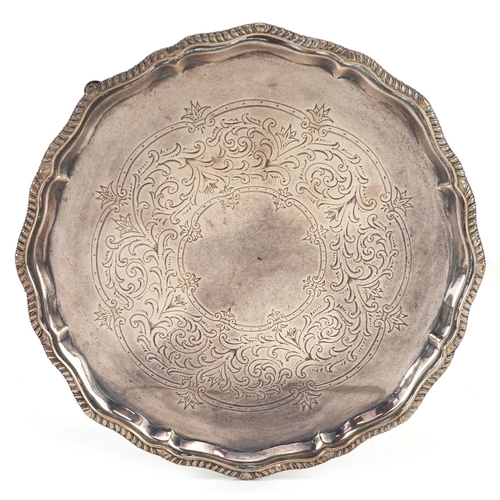 647 - Charles Boyton, a Victorian circular silver engraved salver raised on four hoof feet, London 1892, 2... 