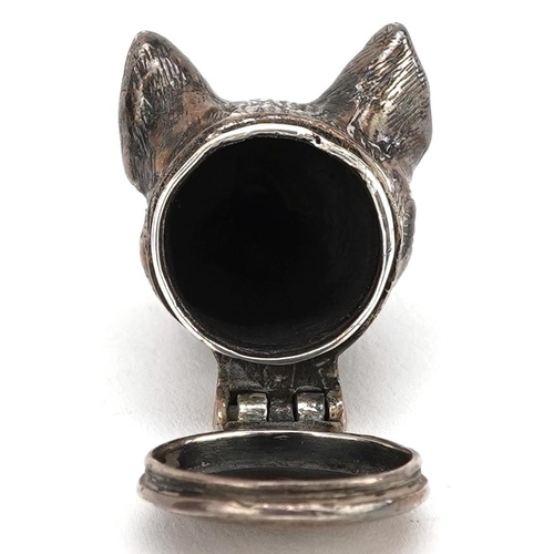 694 - A Victorian novelty silver pill box, with hinged lid in the form of a dog's head, 3.2cm in length, 2... 