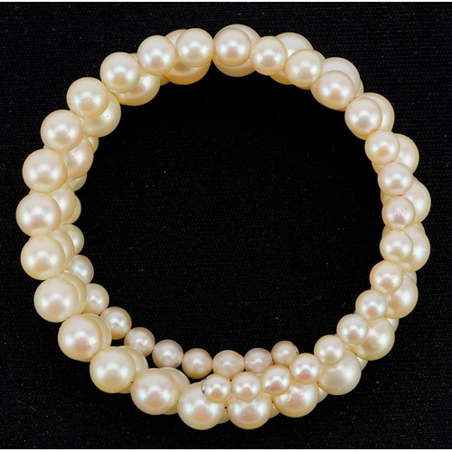 597 - A three row graduated cultured pearl bracelet, the largest pearl 8.2mm in diameter, total 30.4g.