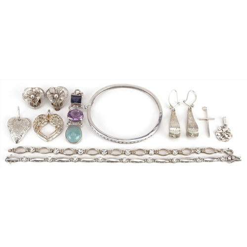 613 - A group of vintage and later silver and white metal jewellery including a hinged bangle set with cle... 