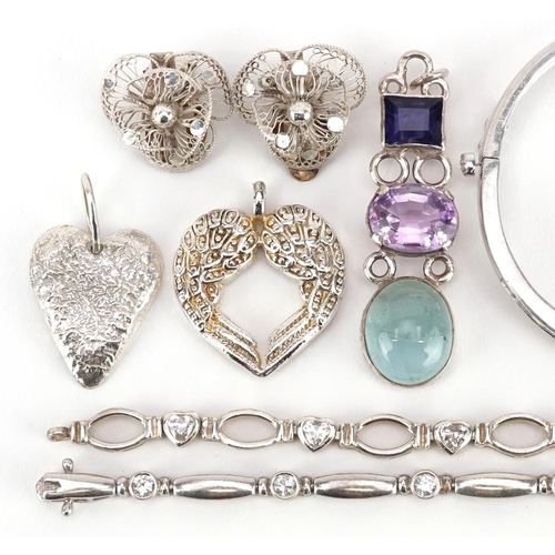 613 - A group of vintage and later silver and white metal jewellery including a hinged bangle set with cle... 