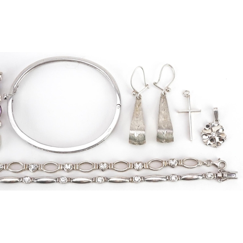 613 - A group of vintage and later silver and white metal jewellery including a hinged bangle set with cle... 