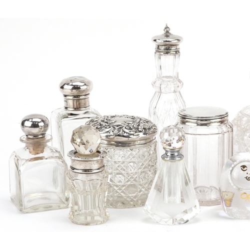 700 - A collection of Victorian and later silver mounted cut glass jars and scent bottles together with a ... 