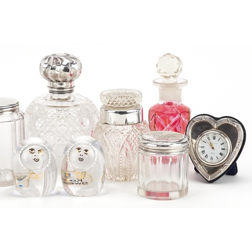 700 - A collection of Victorian and later silver mounted cut glass jars and scent bottles together with a ... 