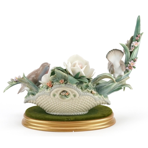 777 - A Lladro study of two birds sitting on flowers, decorated by E. Ordaz, - numbered N-762, 31cm in len... 