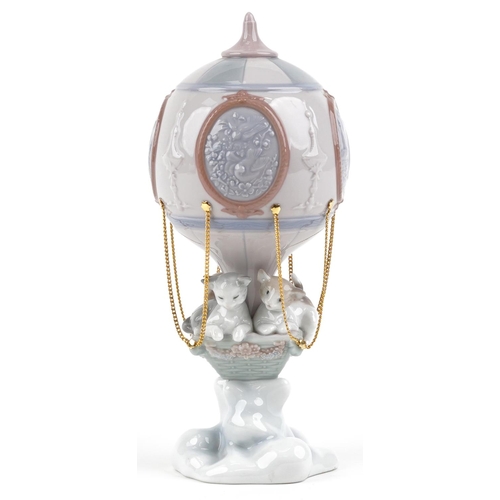 755 - A Lladro figure of a cat sitting in a hot air balloon - Through the Clouds numbered 6522, 24cm high,... 