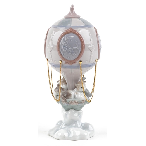 755 - A Lladro figure of a cat sitting in a hot air balloon - Through the Clouds numbered 6522, 24cm high,... 