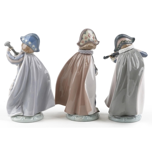 771 - Three Lladro figures of Harlequin playing music - Mandolin Serenade numbered 5694, Concertina number... 