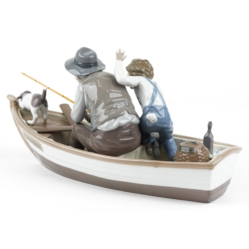 720 - A large Lladro figure group of a gentleman and a young boy fishing on a boat - Fishing with Gramps, ... 