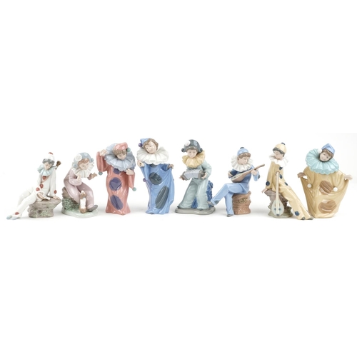 779 - Eight Nao porcelain figures including Harlequin boy with puppy and Harlequin musician boy, the large... 