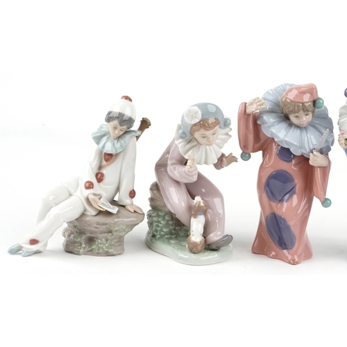 779 - Eight Nao porcelain figures including Harlequin boy with puppy and Harlequin musician boy, the large... 