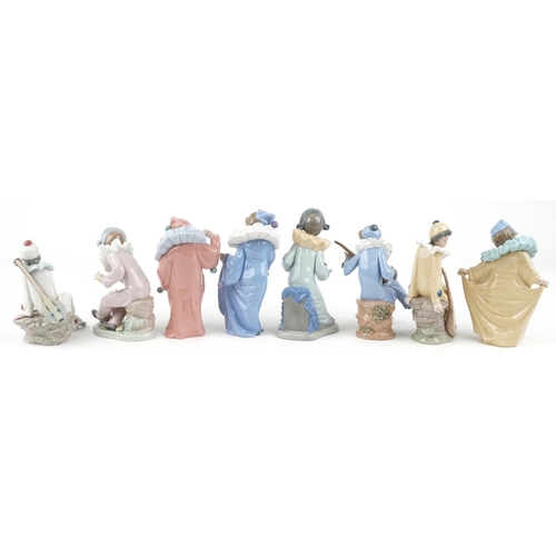 779 - Eight Nao porcelain figures including Harlequin boy with puppy and Harlequin musician boy, the large... 