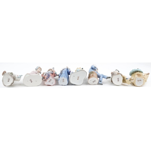 779 - Eight Nao porcelain figures including Harlequin boy with puppy and Harlequin musician boy, the large... 