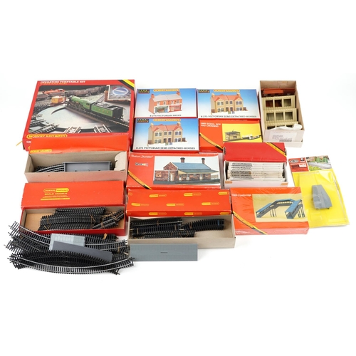 575 - An extensive collection of Hornby OO gauge model railway trackside buildings, track and accessories.