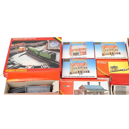 575 - An extensive collection of Hornby OO gauge model railway trackside buildings, track and accessories.