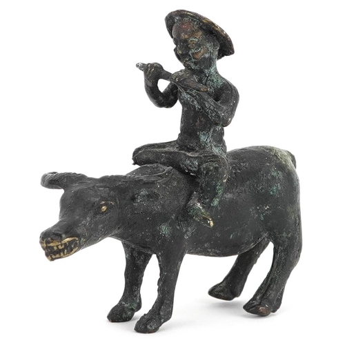 147 - A Chinese bronze figure group of man on the back of a water buffalo, 20th century, 10cm high.