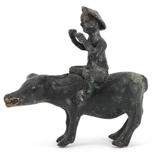 147 - A Chinese bronze figure group of man on the back of a water buffalo, 20th century, 10cm high.