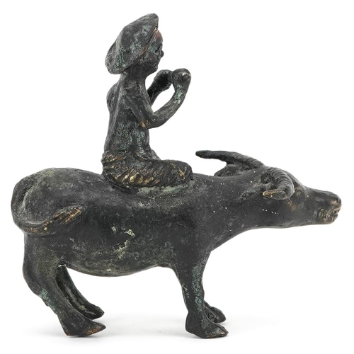 147 - A Chinese bronze figure group of man on the back of a water buffalo, 20th century, 10cm high.