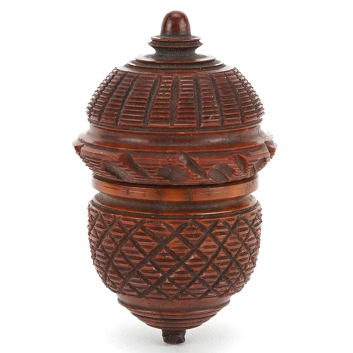 A 19th century carved treen nutmeg grater in the form of an acorn, 7cm wide.