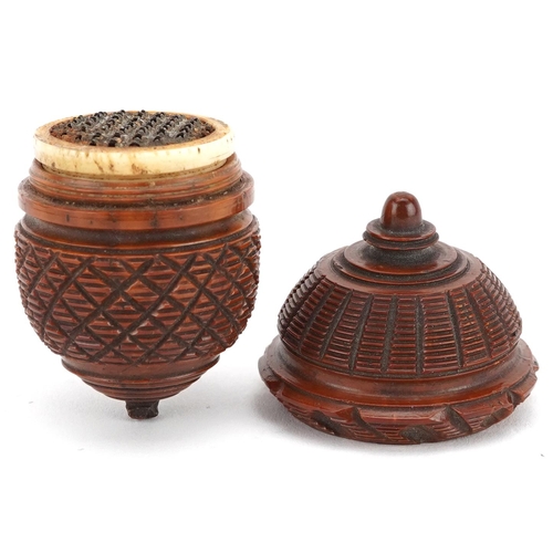 129 - A 19th century carved treen nutmeg grater in the form of an acorn, 7cm wide.