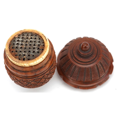 129 - A 19th century carved treen nutmeg grater in the form of an acorn, 7cm wide.