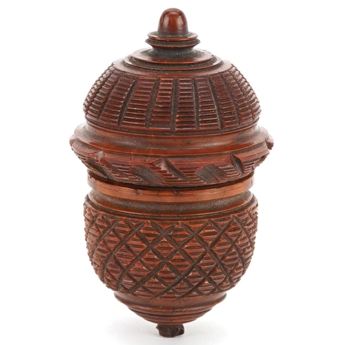 129 - A 19th century carved treen nutmeg grater in the form of an acorn, 7cm wide.