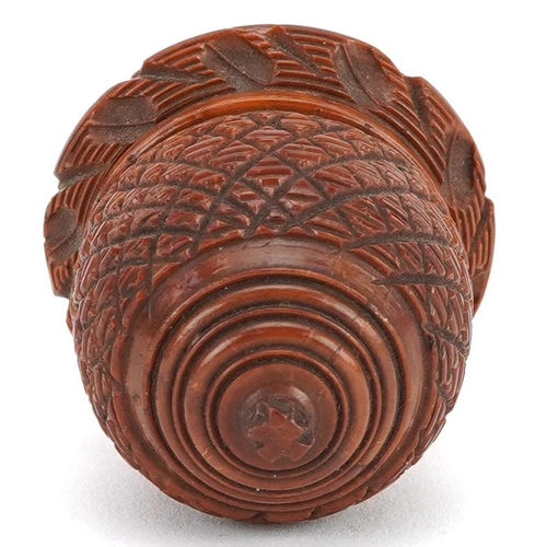 129 - A 19th century carved treen nutmeg grater in the form of an acorn, 7cm wide.