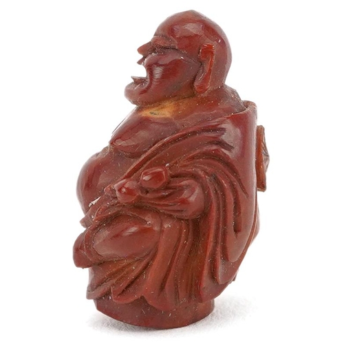 106 - A small Chinese carved nut in the figure of a Buddha, late 19th/early 20th century, 2cm high.