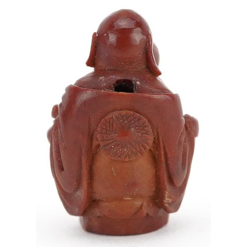 106 - A small Chinese carved nut in the figure of a Buddha, late 19th/early 20th century, 2cm high.