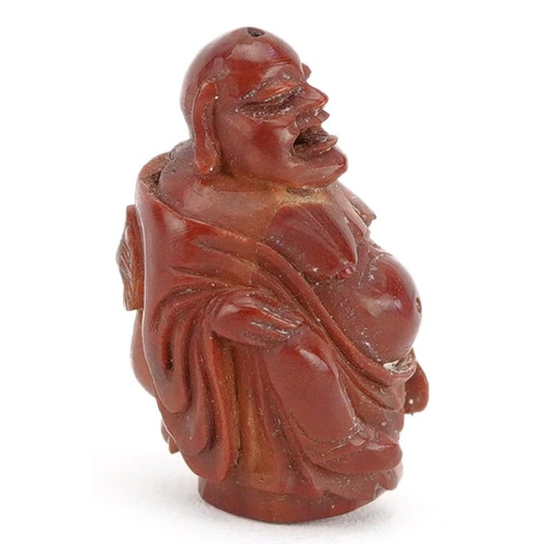 106 - A small Chinese carved nut in the figure of a Buddha, late 19th/early 20th century, 2cm high.