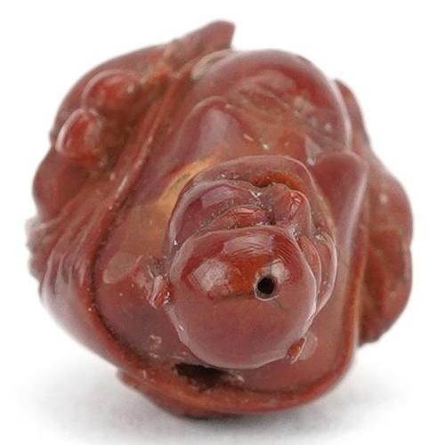 106 - A small Chinese carved nut in the figure of a Buddha, late 19th/early 20th century, 2cm high.