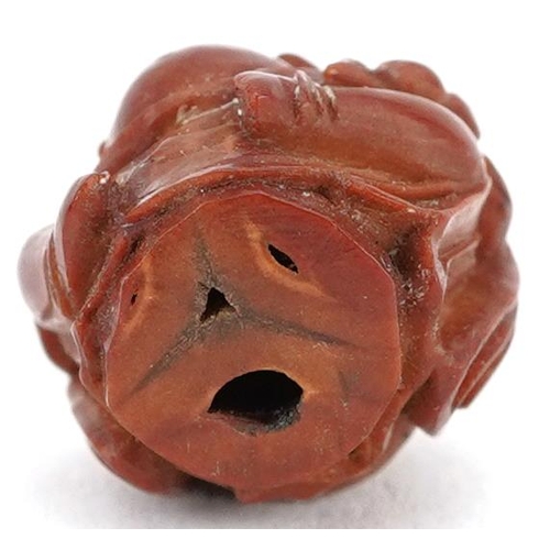 106 - A small Chinese carved nut in the figure of a Buddha, late 19th/early 20th century, 2cm high.