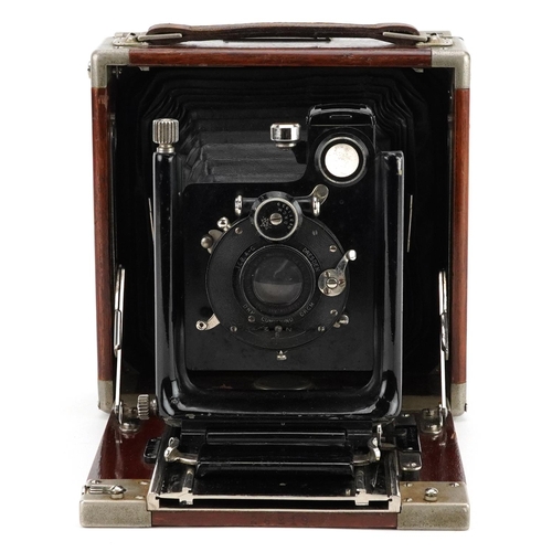 476 - An early 20th century Ika, Dresden quarter-plate mahogany case field camera, 16cm wide.