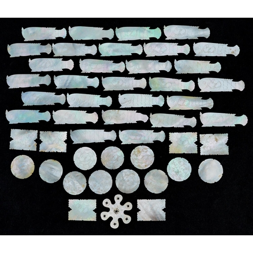 104 - A collection of Chinese carved mother of pearl gaming tokens including some in the form of fish, the... 