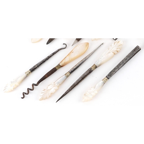 40 - A collection of 19th century and later mother of pearl and steel vanity tools, the largest 11cm in l... 