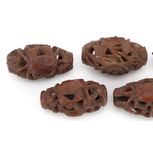 105 - Seven Chinese carved coquilla nuts, the largest 3cm in length.