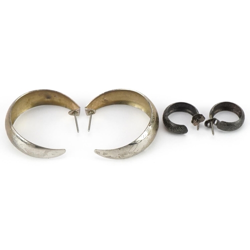 2532 - Two pairs of white metal hoop earrings with engraved decoration, the largest 3.5cm in diameter, tota... 