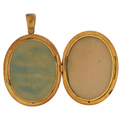 2067 - Victorian unmarked gold locket by Harry Emanuel, tests as 15ct gold, relief decorated with a bird in... 